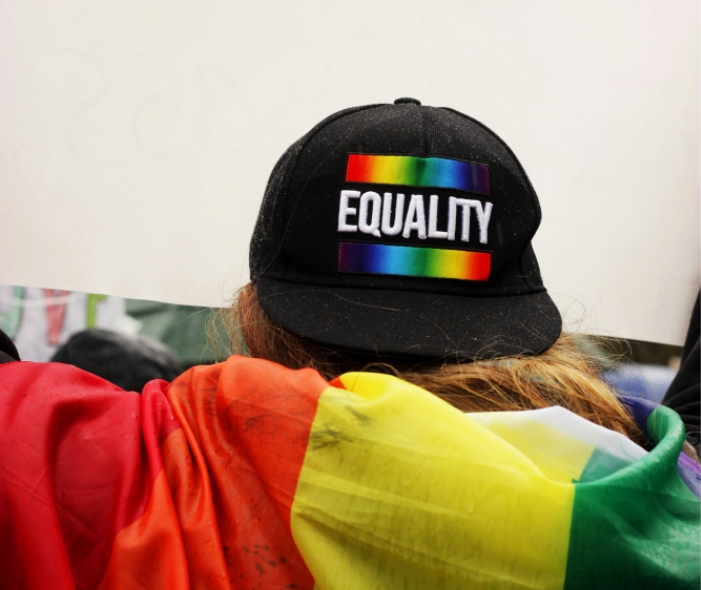a person wear a pride hat and apparel
